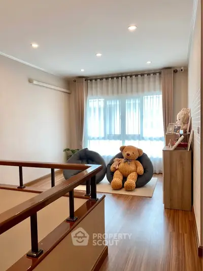 Cozy living room with plush seating and large teddy bear, perfect for relaxation.