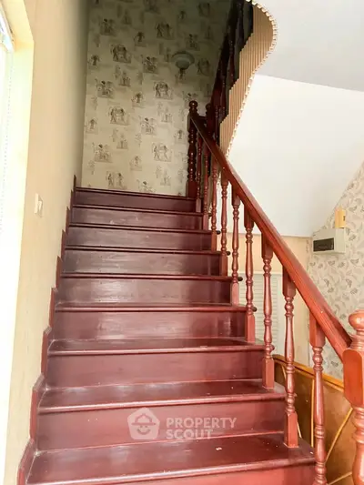Charming wooden staircase with elegant railing in a cozy home interior