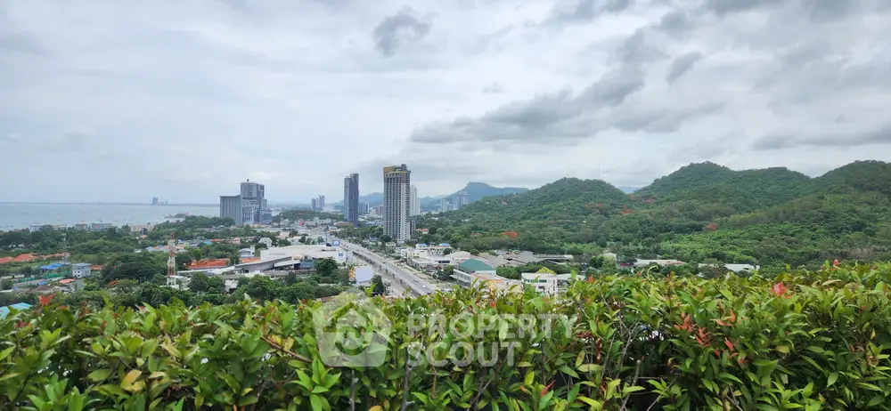 Stunning panoramic city and mountain view from a lush green rooftop garden