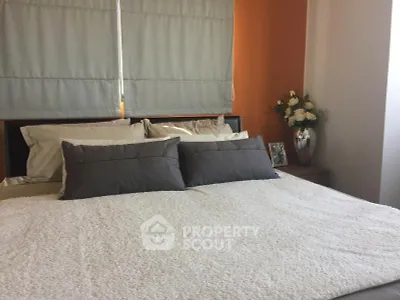 Cozy bedroom with stylish decor and plush bedding in modern apartment.