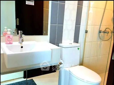 Modern bathroom with sleek fixtures and stylish tiles in a contemporary apartment.