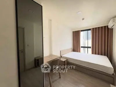 Modern minimalist bedroom with large window and sleek furniture