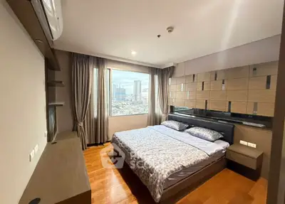 Spacious bedroom with city view and modern decor in high-rise apartment