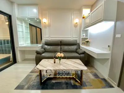 Elegant living room with modern furniture, sleek white cabinetry, and a stylish coffee table, complemented by warm lighting and a cozy ambiance.