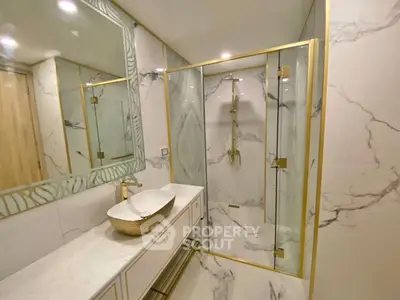 Luxurious marble bathroom with gold accents and modern fixtures