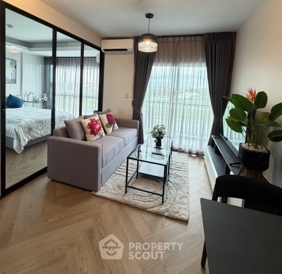 Modern living room with elegant decor and large windows offering natural light and scenic views.