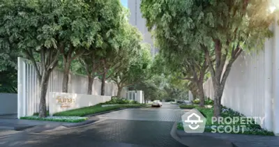 Serene tree-lined entrance to a luxury residential complex, showcasing lush greenery and a welcoming, secure atmosphere for discerning homeowners.