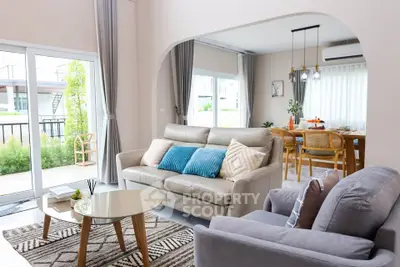 Spacious living room with modern decor and large windows for natural light.