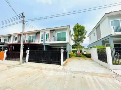 Modern townhouse with gated entrance and driveway in a suburban neighborhood.