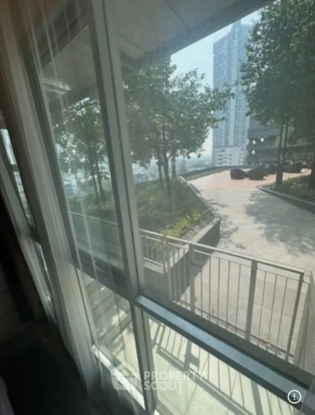 Spacious apartment window view overlooking urban garden and cityscape