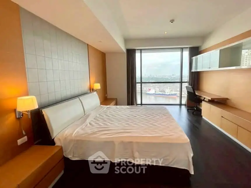 Spacious bedroom with modern design and stunning city view.