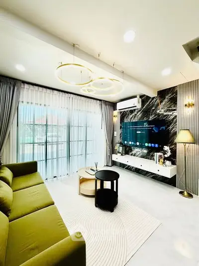 Luxurious modern living room with stylish decor and large windows for natural light.