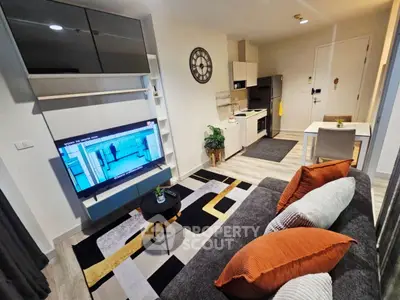Modern living room with stylish decor and open kitchen layout in a cozy apartment.