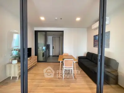 Modern living room with sleek furniture and wooden flooring in a stylish apartment.