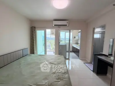Spacious bedroom with balcony and scenic view in modern apartment