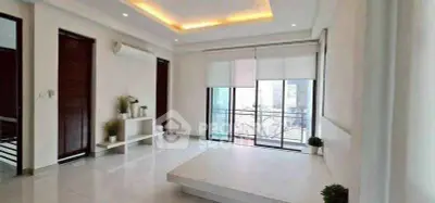 Spacious modern living room with large windows and minimalist decor
