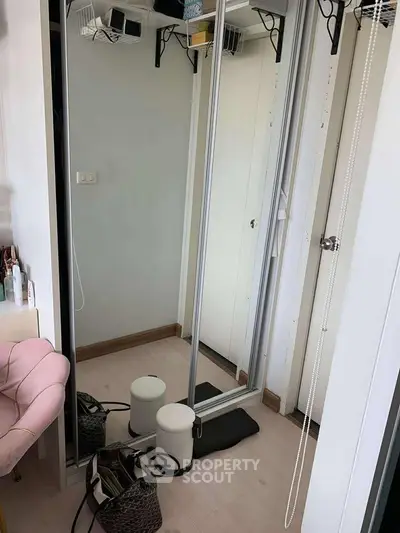 Cozy bedroom corner with mirrored wardrobe and stylish decor