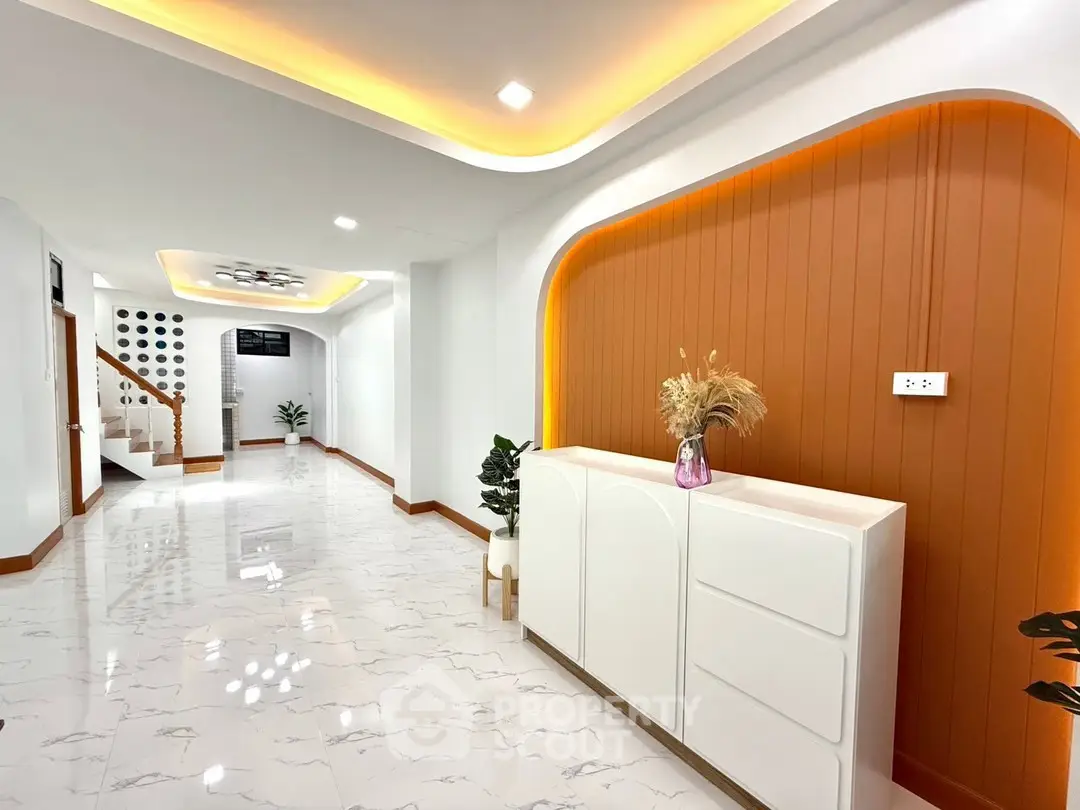 Modern hallway with elegant lighting and sleek white cabinetry