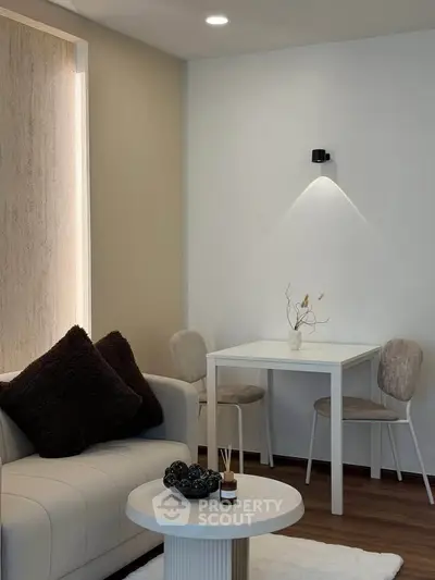 Modern living room with cozy seating and stylish decor, perfect for relaxation and entertaining.