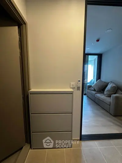Modern apartment interior with cozy living room and stylish storage unit.