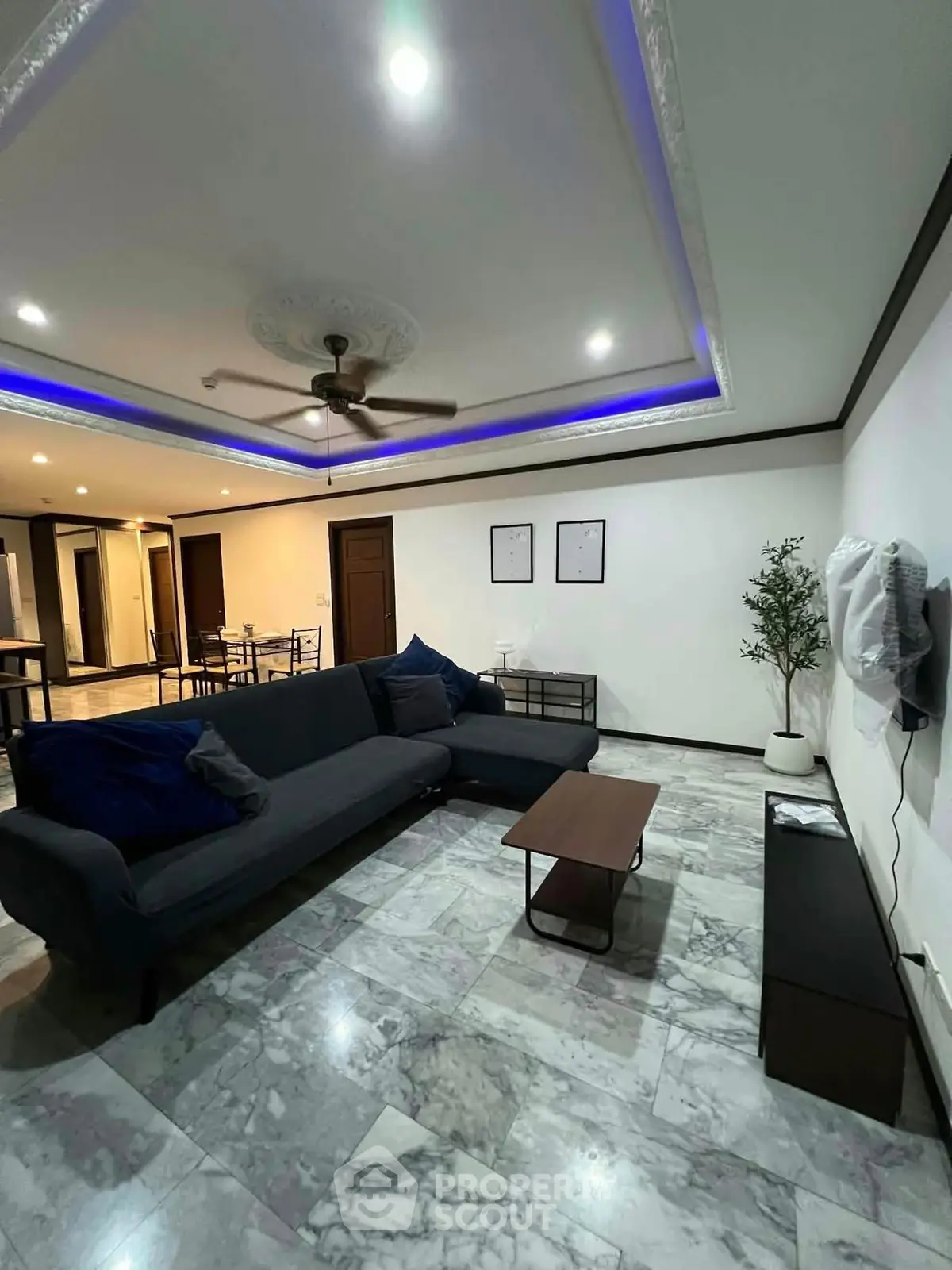 Spacious living room with modern decor and elegant ceiling design