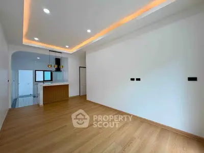 Spacious modern living room with open kitchen and elegant lighting
