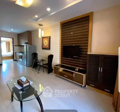 Modern open-plan living room with sleek furniture and integrated kitchen appliances.