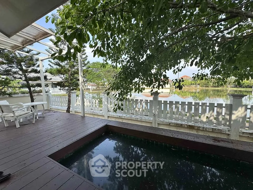 Charming outdoor deck with private pool and serene lake view, perfect for relaxation and entertaining.