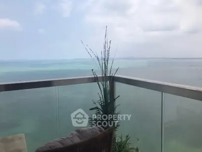 Stunning ocean view from a modern glass balcony, perfect for relaxation and enjoying the serene seascape.