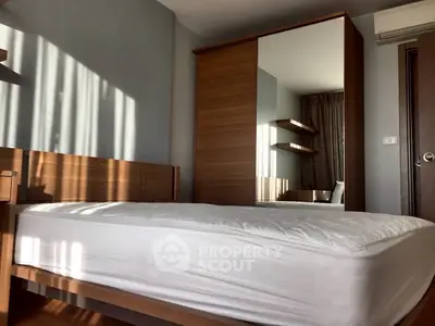 Modern bedroom with sleek wooden furniture and ample natural light