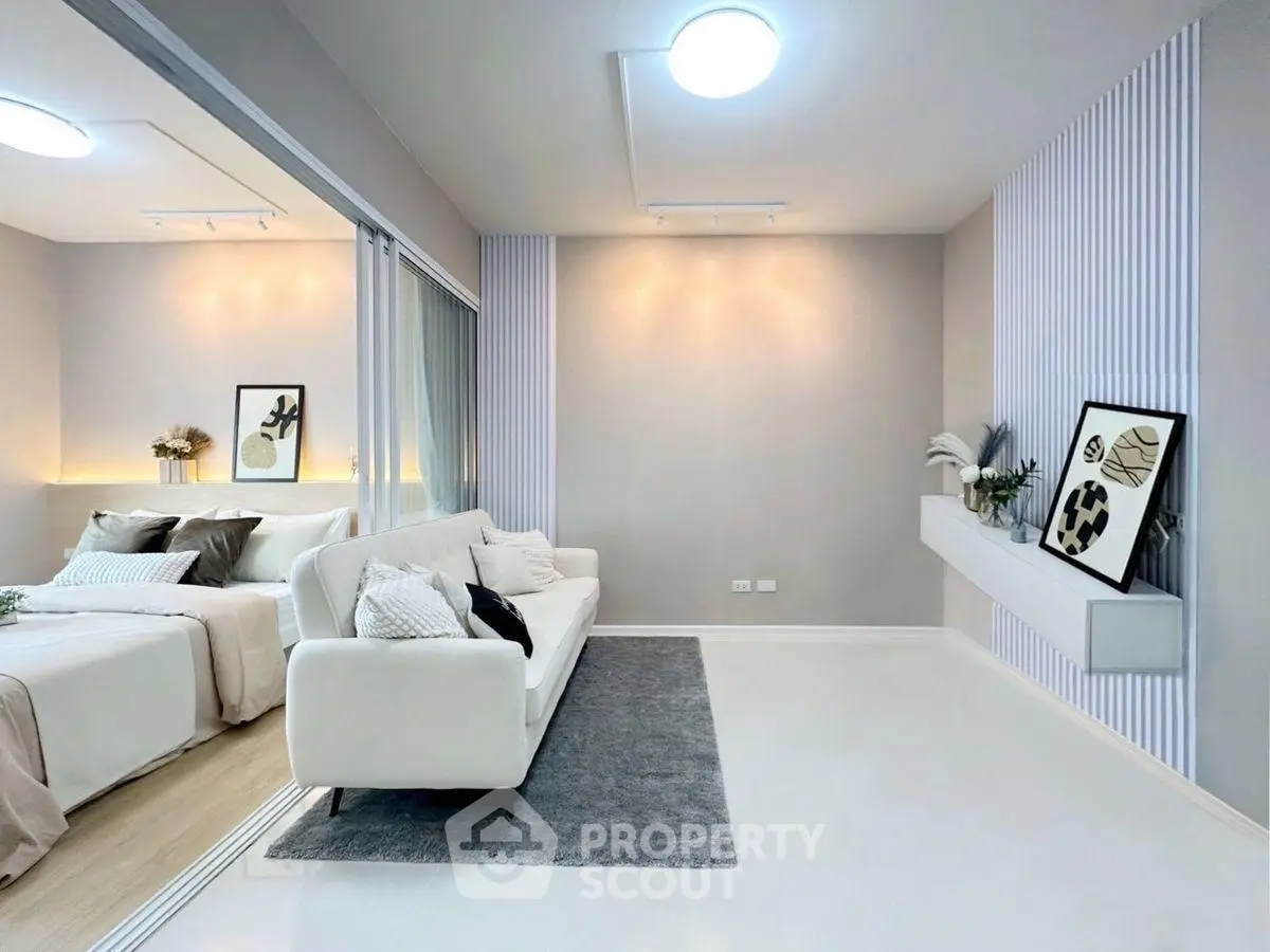 Modern living room with elegant decor and cozy bedroom view