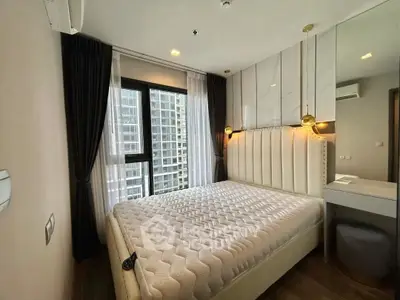 Modern bedroom with large window and stylish decor in high-rise apartment.