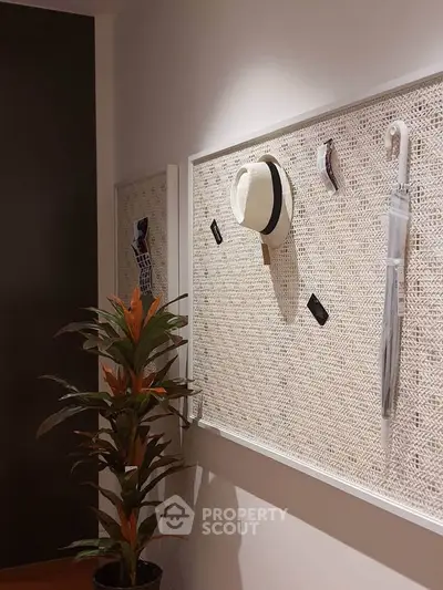 Stylish entryway with decorative wall panel and indoor plant