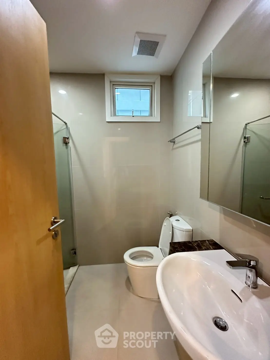 Modern bathroom with sleek fixtures and glass shower enclosure