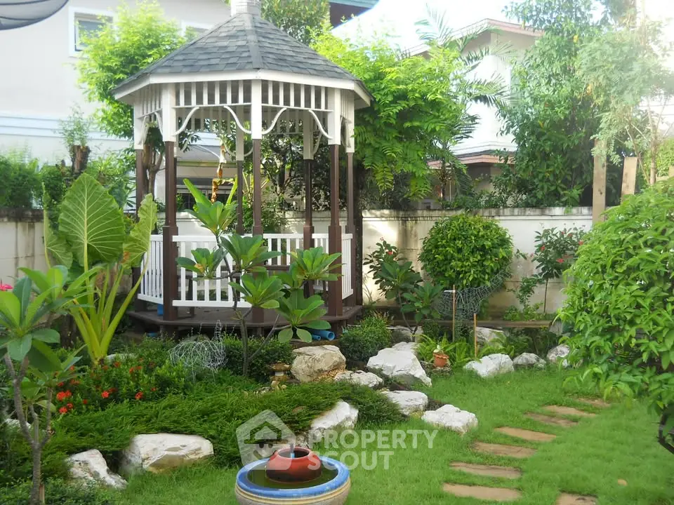 Charming garden with gazebo and lush greenery, perfect for relaxation and outdoor enjoyment.
