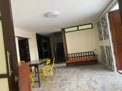 Spacious living area with modern furniture and natural light, perfect for relaxation and entertaining.