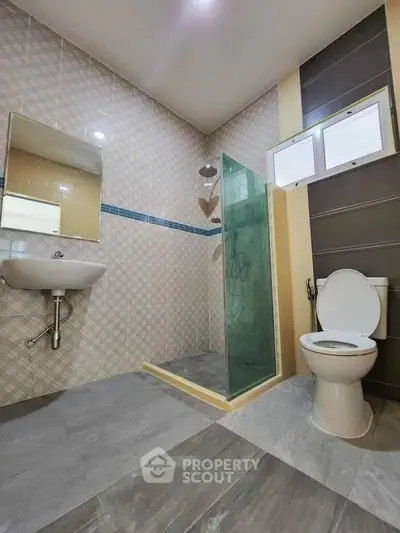 Modern bathroom with glass shower and sleek fixtures