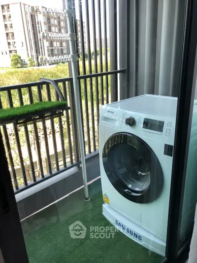 Compact balcony with Samsung washing machine and artificial grass flooring