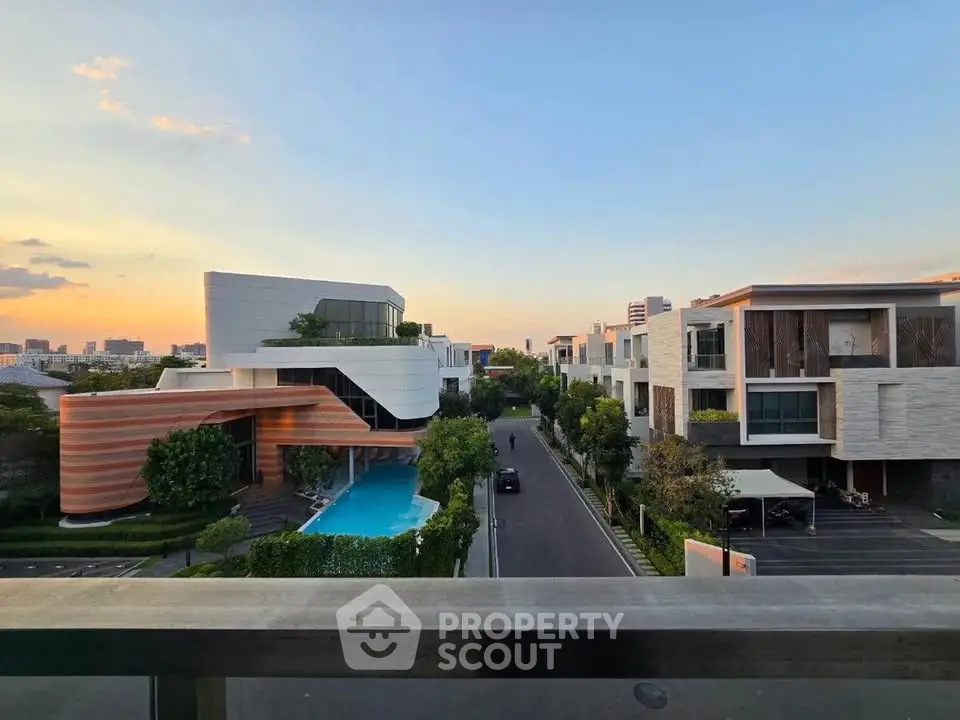 Luxurious modern homes with private pools and stunning sunset views in an upscale neighborhood.