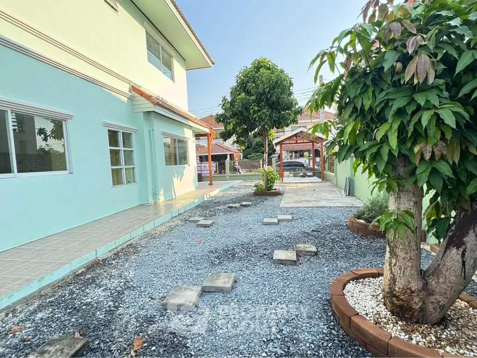 Charming residential property with spacious garden and paved walkway, perfect for outdoor relaxation.