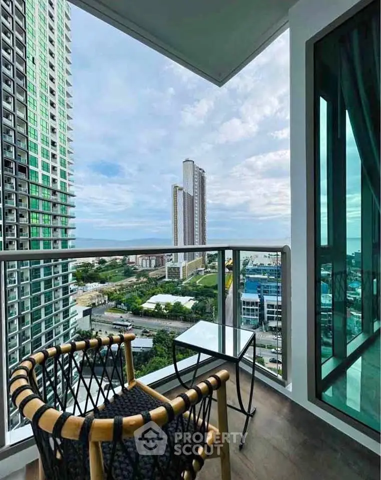 Stunning balcony view from modern high-rise apartment with cityscape and sky panorama.