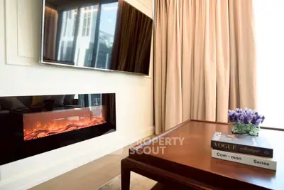 Luxurious living room with modern fireplace and large TV, elegant decor
