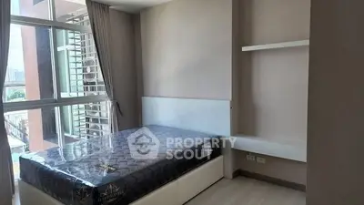 Modern bedroom with large window and built-in shelves in a stylish apartment.