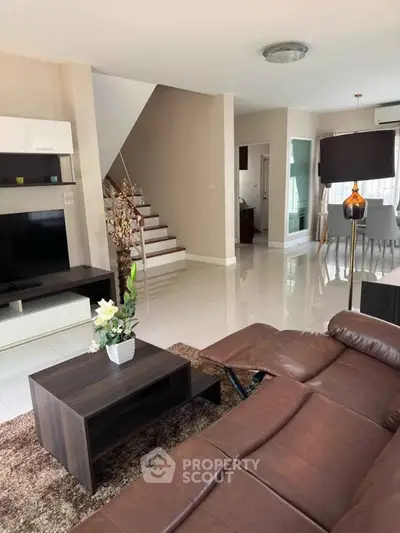 Spacious modern living room with leather sofa and elegant decor