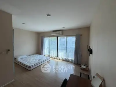 Spacious bedroom with large windows and natural light