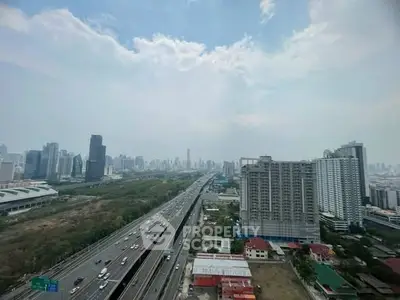 Stunning cityscape view from high-rise building showcasing urban skyline and bustling highway.