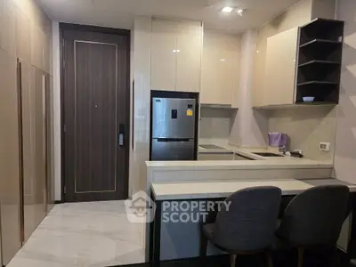 Modern kitchen with sleek cabinetry and breakfast bar seating