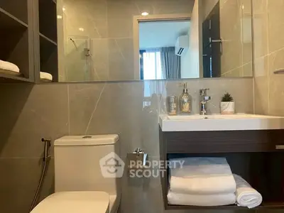 Modern bathroom with elegant fixtures and ample storage space.