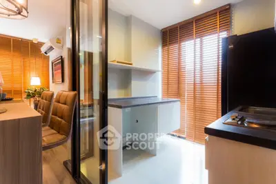 Modern kitchen with sleek design and natural light through wooden blinds