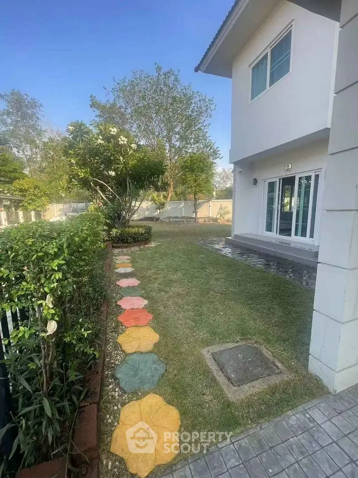 Charming suburban home with lush garden and patio area, perfect for outdoor relaxation.